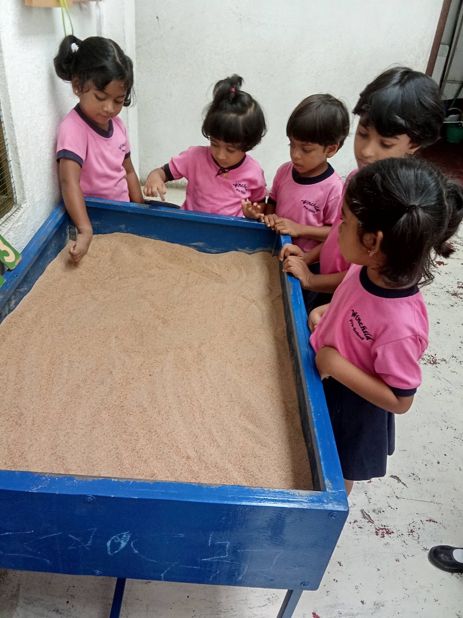 Children playing and learning at the sand table