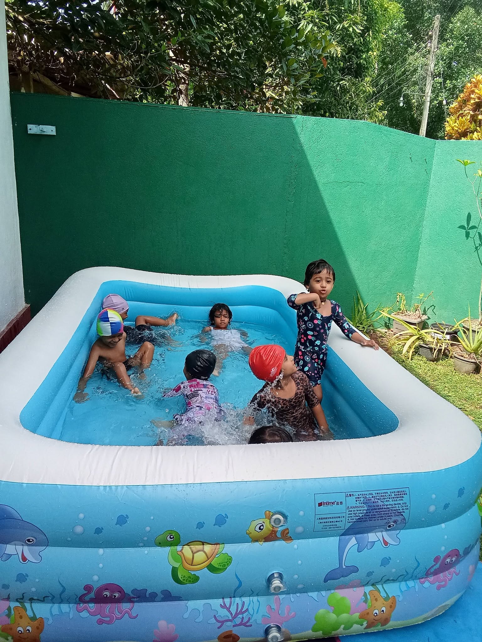 Children enjoying water play in the pool
