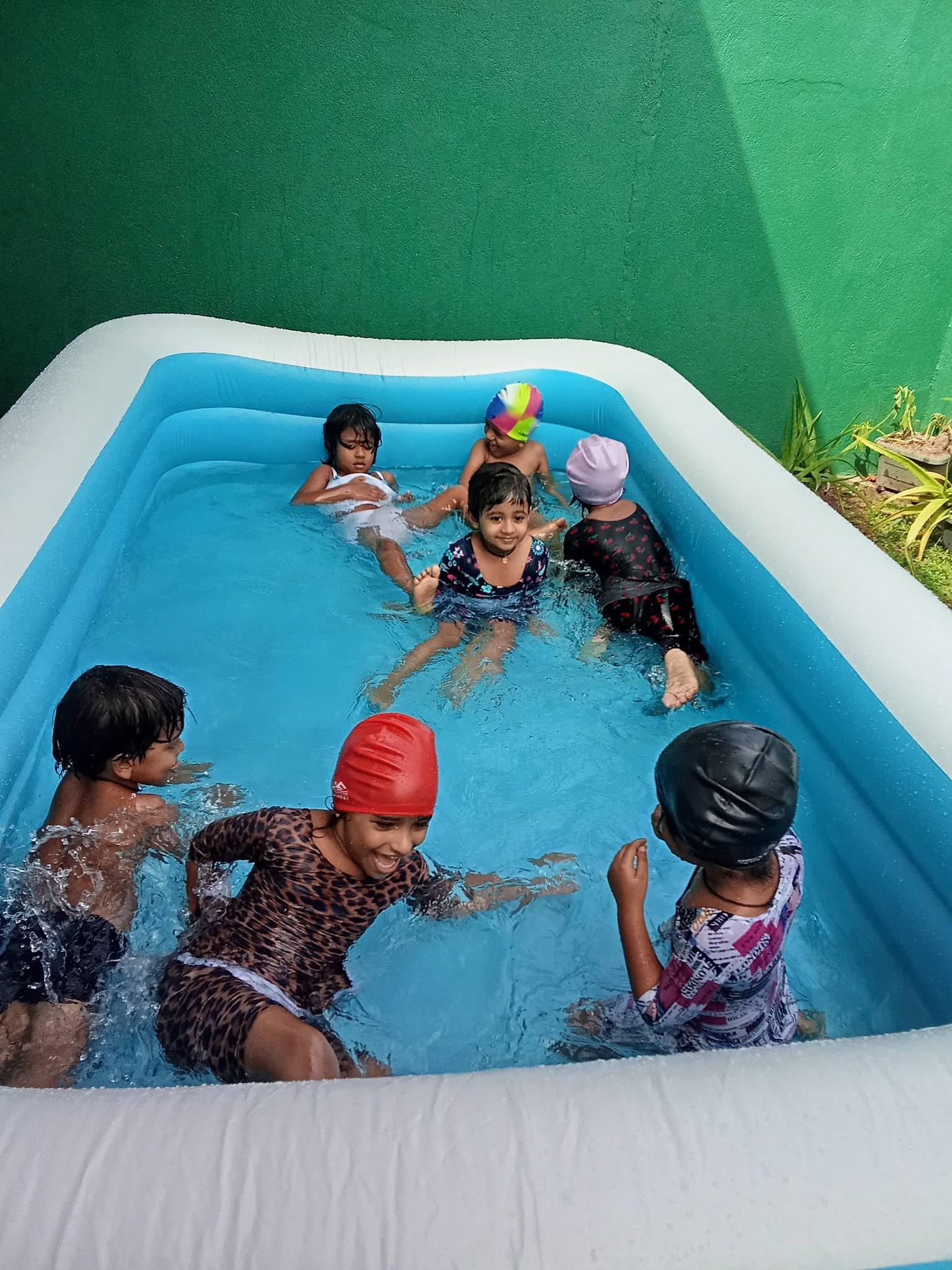 Children enjoying water play in the pool